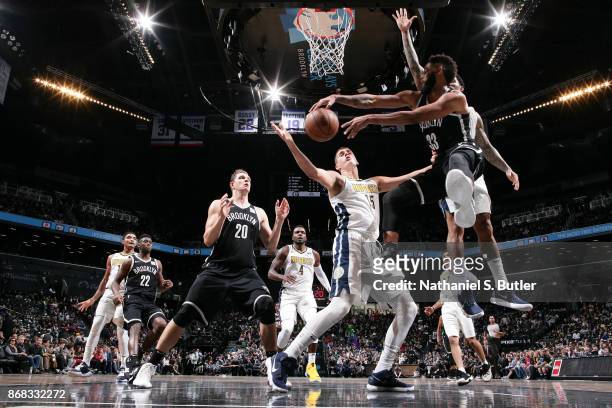 Allen Crabbe of the Brooklyn Nets passes the ball against the Denver Nuggets on October 29, 2017 at Barclays Center in Brooklyn, New York. NOTE TO...