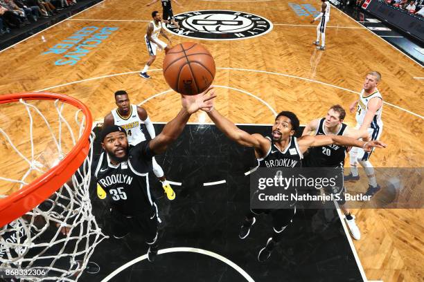 Trevor Booker and Spencer Dinwiddie of the Brooklyn Nets goes up for a rebound against the Denver Nuggets on October 29, 2017 at Barclays Center in...