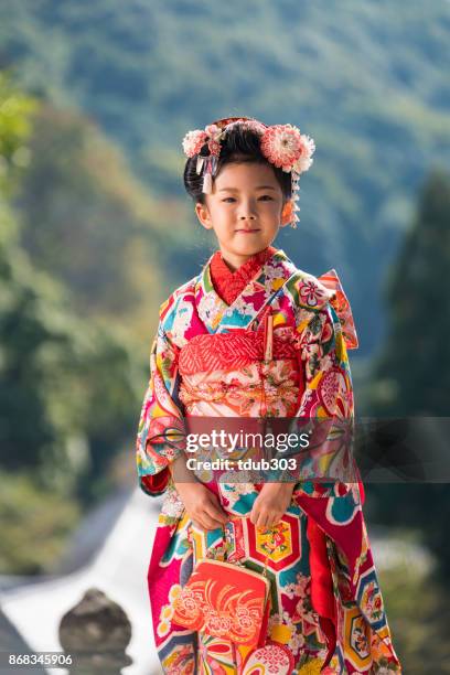 a young japanese girl wearing a traditional kimono while celebrating her shichi go san - traditional clothing stock pictures, royalty-free photos & images