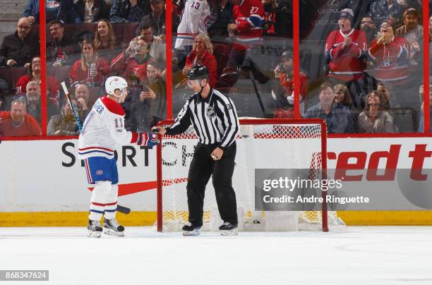 Brendan Gallagher of the Montreal Canadiens picks up a puck from linesman Devin Berg for teammate Charles Hudon who scored hist first career HL goal...