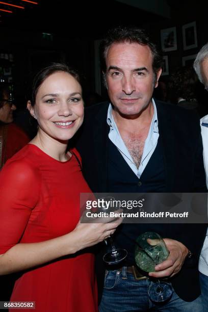 Jean Dujardin and Nathalie Pechalat attend Claude Lelouch celebrates his 80th Birthday at Restaurant Victoria on October 30, 2017 in Paris, France.