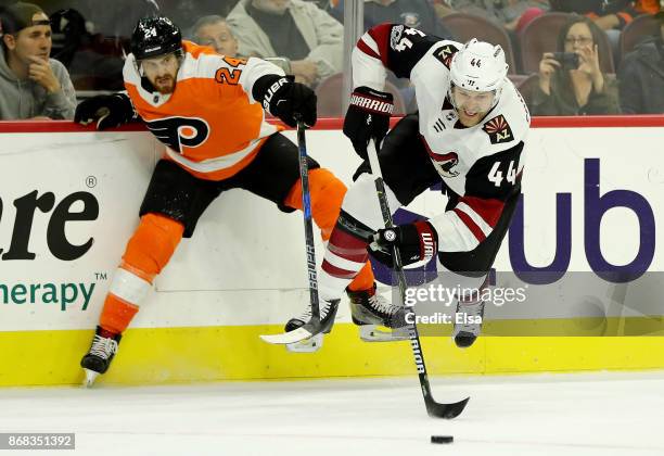 Kevin Connauton of the Arizona Coyotes tries to keep the puck as Matt Read of the Philadelphia Flyers defends on October 30, 2017 at Wells Fargo...