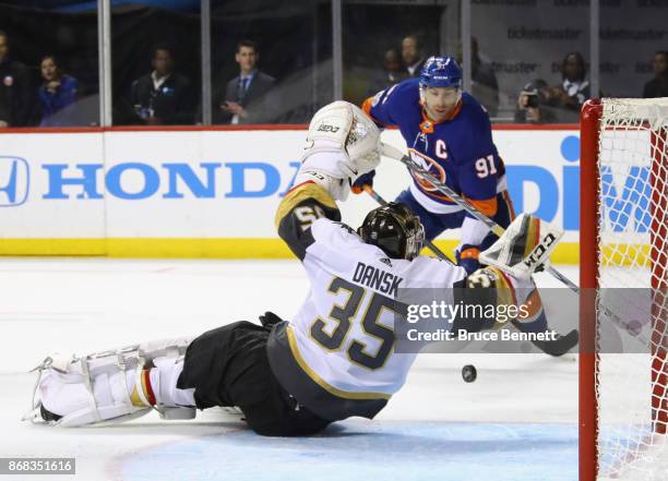 Oscar Dansk of the Vegas Golden Knights blocks the net against John Tavares of the New York Islanders during the second period at the Barclays Center...