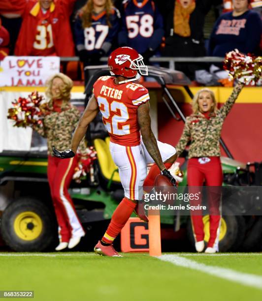 Cornerback Marcus Peters of the Kansas City Chiefs crosses the goal line for a touchdown after returning a fumble against the Denver Broncos during...