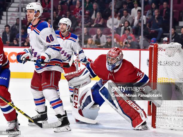 Goaltender Carey Price of the Montreal Canadiens tries to look past Michael Grabner of the New York Rangers during the NHL game at the Bell Centre on...