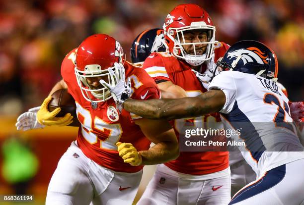 Tight end Travis Kelce of the Kansas City Chiefs fights through the tackle attempt of cornerback Aqib Talib of the Denver Broncos during the first...