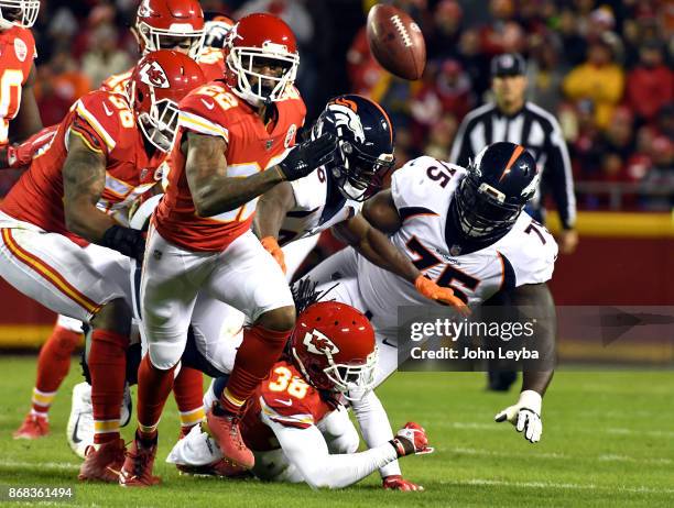 Kansas City Chiefs cornerback Marcus Peters strips the ball from Denver Broncos running back Jamaal Charles during the first quarter on October 30,...