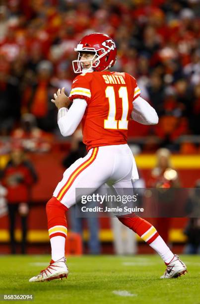 Quarterback Alex Smith of the Kansas City Chiefs drops back to throw a pass against the Denver Broncos during the first quarter of the game at...