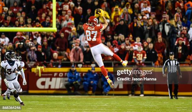 Tight end Travis Kelce of the Kansas City Chiefs leaps to make a reception during the game against the Denver Broncos during the first quarter of the...