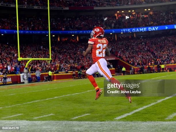 Kansas City Chiefs cornerback Marcus Peters head to the end zone for a core after picking up fumble after stripping the ball from Denver Broncos...