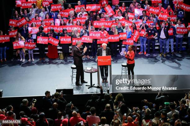 Sen. Bernie Sanders speaks to supporters next to New York City Mayor Bill de Blasio and the mayor's wife Chirlane McCray as they take part in a...