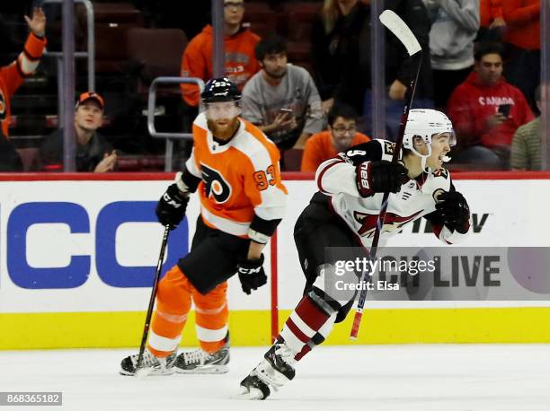 Clayton Keller of the Arizona Coyotes celebrates teammate Alex Goligoski's game winning goal as Jakub Voracek of the Philadelphia Flyers reacts in...