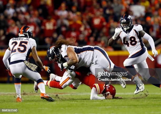 Nose tackle Domata Peko of the Denver Broncos is tackled by quarterback Alex Smith of the Kansas City Chiefs after recovering a fumble during the...