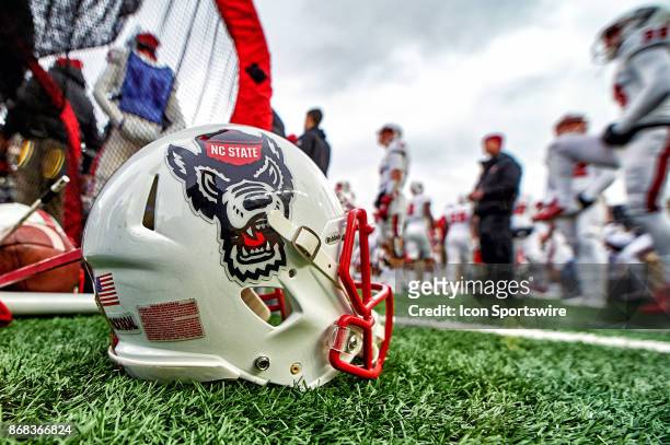 Detailed view of a North Carolina State Wolfpack football helmet rests on the ground during the college football game between the Notre Dame Fighting...