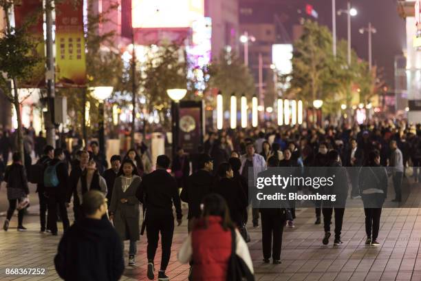 Shoppers and pedestrians walk through Wangfujing Street at night in Beijing, China, on Monday, Oct. 23, 2017. The worlds second-largest economy will...