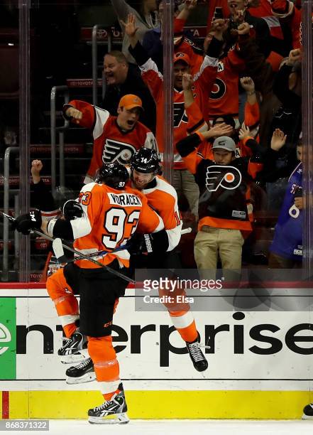Sean Couturier of the Philadelphia Flyers celebrates his goal with teammate Jakub Voracek in the third period to tie the game against the Arizona...