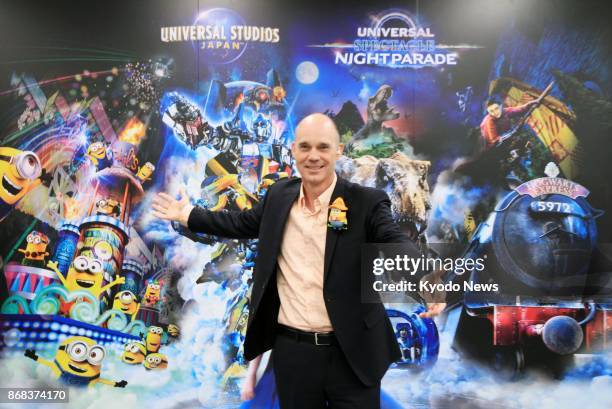 Jean Louis Bonnier, chief executive officer of USJ Co., the operator of Universal Studios Japan in Osaka, poses for photos on Oct. 30 in front of a...