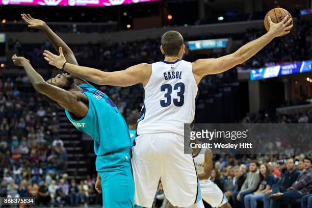 Marc Gasol of the Memphis Grizzlies reaches for a pass and fouls Michael Kidd-Gilchrist of the Charlotte Hornets at the FedEx Forum on October 30,...