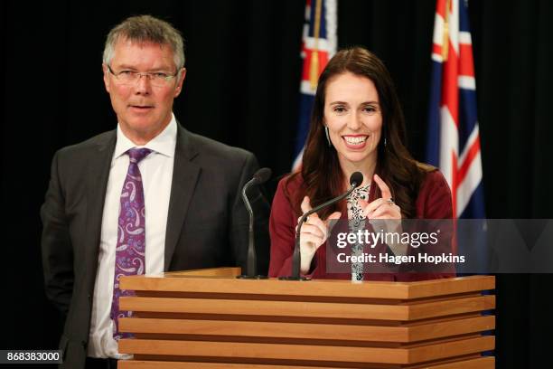 Prime Minister Jacinda Ardern speaks while Minister for Economic Development David Parker looks on during a post cabinet press conference at...