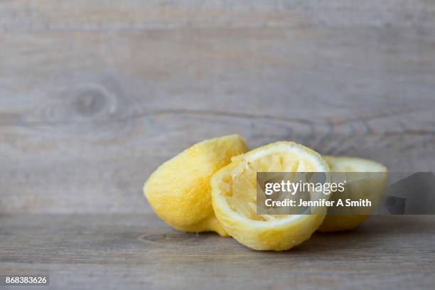 squeezed lemons - saftpresse stock-fotos und bilder