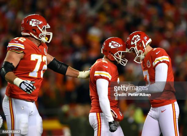 Kicker Harrison Butker of the Kansas City Chiefs is congratulaed by punter Dustin Colquitt and offensive tackle Eric Fisher after making a field goal...