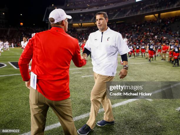 Head coach Luke Fickell of the Cincinnati Bearcats congratulates Head coach Chad Morris of the Southern Methodist Mustangs after the game at Nippert...