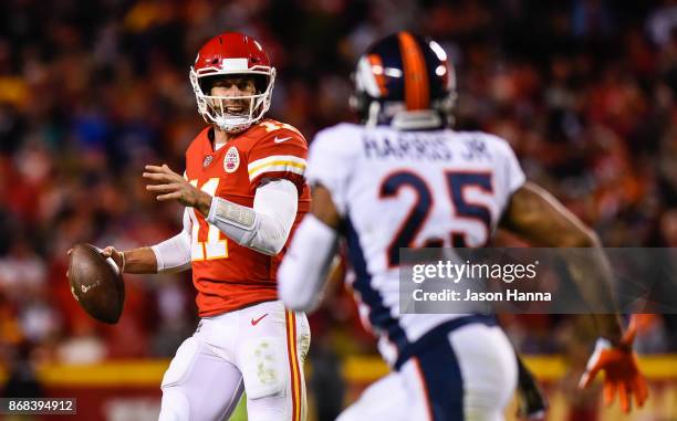 Quarterback Alex Smith of the Kansas City Chiefs is pressured out of the pocket by cornerback Chris Harris of the Denver Broncos during the fourth...