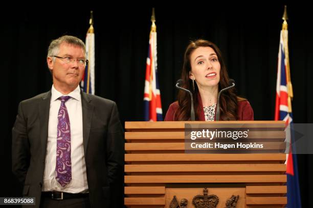 Prime Minister Jacinda Ardern speaks while Minister for Economic Development David Parker looks on during a post cabinet press conference at...