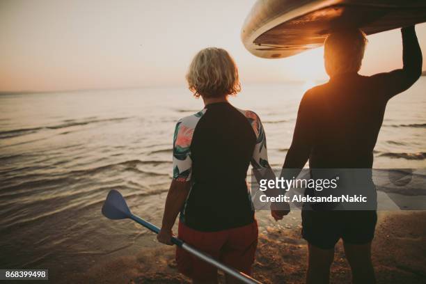 senior surfers - baby boomer stock pictures, royalty-free photos & images