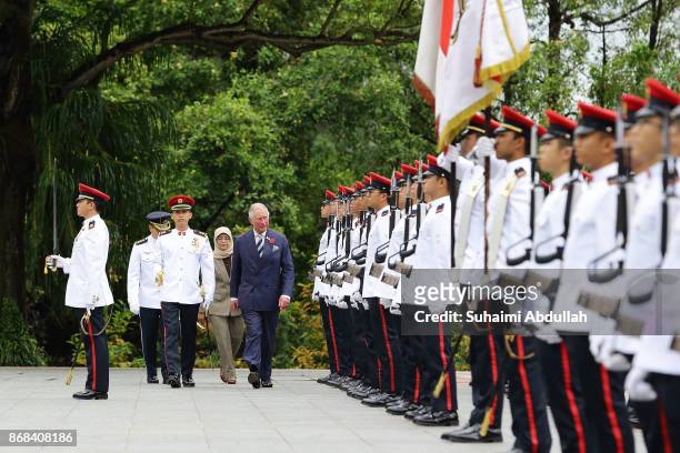 Prince Charles, Prince of Wales inspects the guard of honour, accompanied by Singapore President, Halimah Yacob during the welcome ceremony at the...