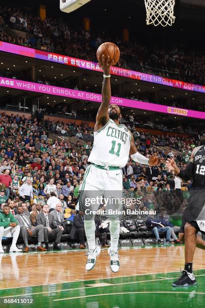 Kyrie Irving of the Boston Celtics drives to the basket against the San Antonio Spurs on October 30, 2017 at the TD Garden in Boston, Massachusetts....