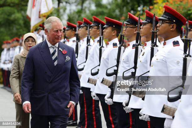 Prince Charles, Prince of Wales inspects the guard of honour, accompanied by Singapore President, Halimah Yacob during the welcome ceremony at the...