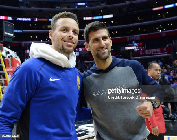 Stephen Curry of the Golden State Warriors poses with tennis player Novak Djokovic after the Warriors defeated the Los Angeles Clippers, 141-113, at...