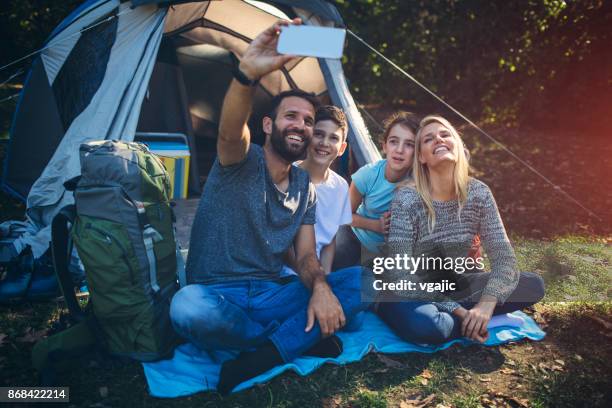 family camping together - boy taking picture in forest stock pictures, royalty-free photos & images