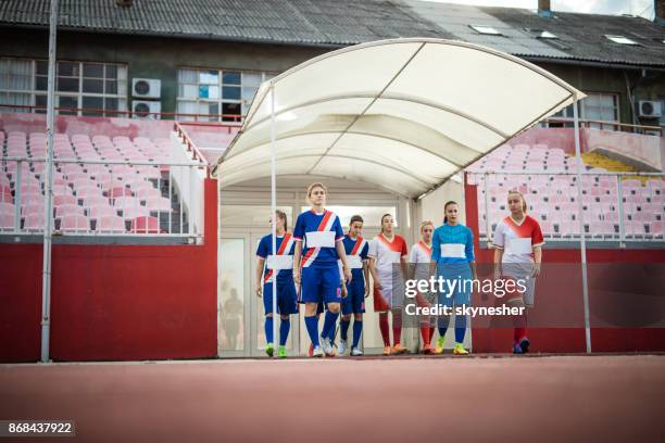sotto la vista delle giocatrici di calcio che entrano nel campo di gioco. - entrare foto e immagini stock
