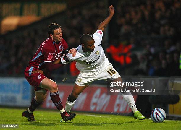 Sam Togwell of Scunthorpe battles with Jason Puncheon of MK Dons during the Coca-Cola Football League One play off semi-final, first leg match...