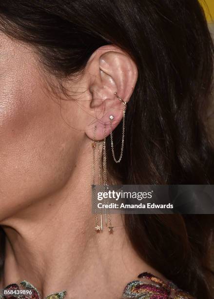 Actress Sarah Wayne Callies, earring detail, arrives at the premiere of National Geographic's "The Long Road Home" at Royce Hall on October 30, 2017...