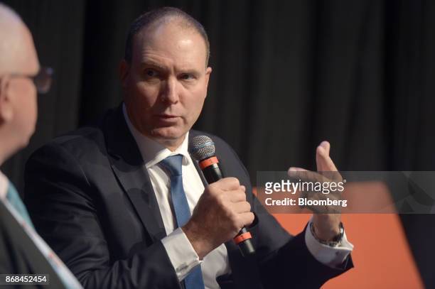 Nev Power, chief executive officer of Fortescue Metals Group Ltd., right, speaks during the International Mining And Resources Conference in...