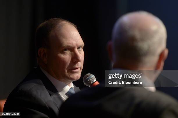 Nev Power, chief executive officer of Fortescue Metals Group Ltd., left, speaks during the International Mining And Resources Conference in...