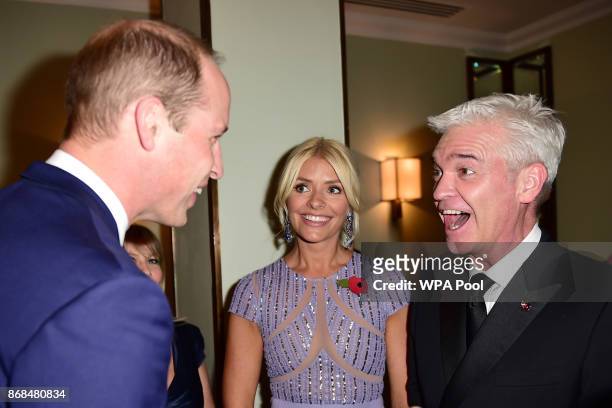 Prince William, Duke of Cambridge greets Holly Willoughby and Philip Schofield as he attends the Pride Of Britain Awards at the Grosvenor House on...