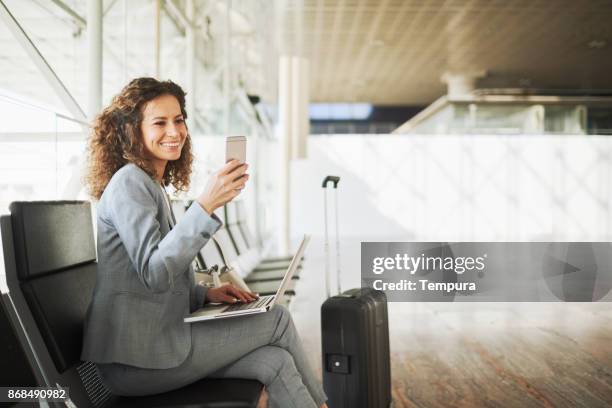 single business woman commuting, on the move. - businesswoman airport stock pictures, royalty-free photos & images