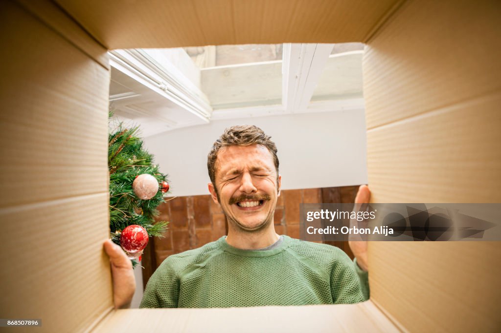 Man opening Christmas present