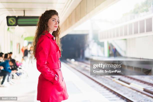 hoping the next train is hers - trench coat stock pictures, royalty-free photos & images