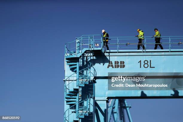 General view of workers in the yard working on shipping containers and the cranes which move them at the Port of Rotterdam on October 27, 2017 in...