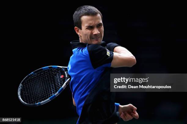 Evgeny Donskoy of Russia plays a forehand against Kyle Edmund of Great Britain during Day 2 of the Rolex Paris Masters held at the AccorHotels Arena...
