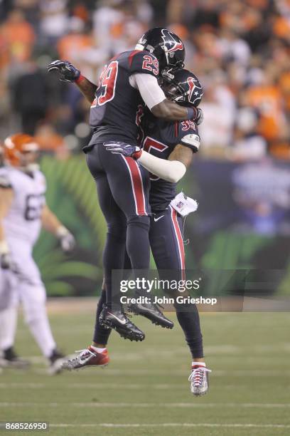 Eddie Pleasant and Andre Hal of the Houston Texans celebrate a defensive stop during their game against the Cincinnati Bengals at Paul Brown Stadium...