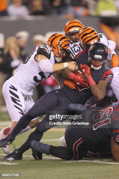 Onta Foreman of the Houston Texans runs the football upfield against Nick Vigil of the Cincinnati Bengals during their game at Paul Brown Stadium on...