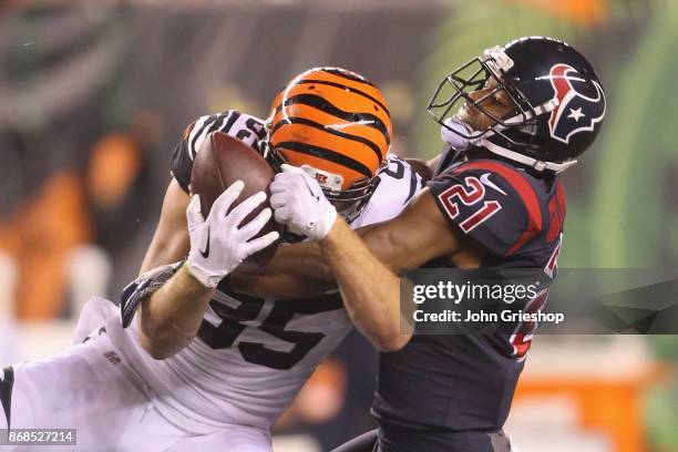 Marcus Gilchrist of the Houston Texans battles for the football against Tyler Eifert of the Cincinnati Bengals during their game at Paul Brown...