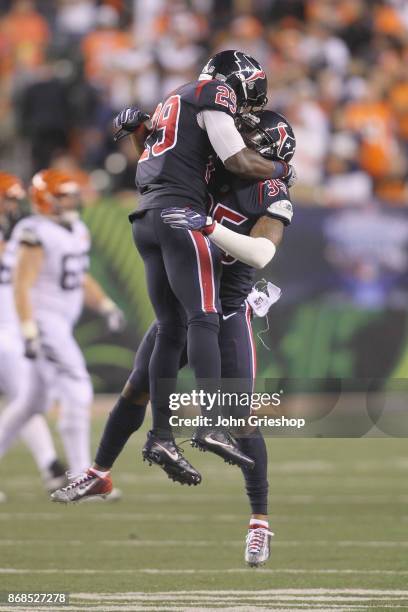 Eddie Pleasant and Andre Hal of the Houston Texans celebrate a defensive stop during their game against the Cincinnati Bengals at Paul Brown Stadium...