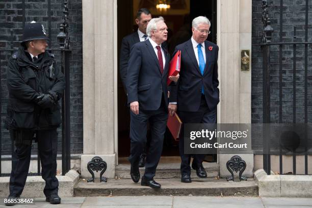 Defence secretary Michael Fallon and Brexit Secretary David Davis leave after attending a cabinet meeting in Downing Street on October 31, 2017 in...